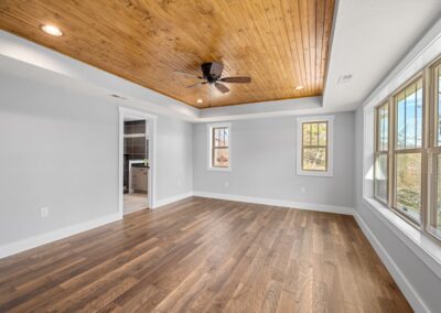 Master bedroom with wood ceiling and floors